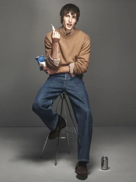 Thatcher Thornton modeling a camel crew neck and denim from FRAME’s Fall 2026 collection