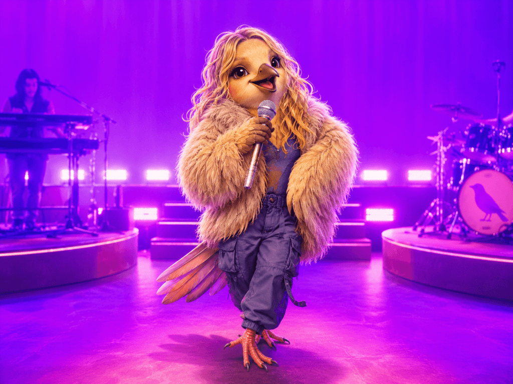 Hilary Duff reimagined as a blond finch performing with a microphone under bright purple concert lights.