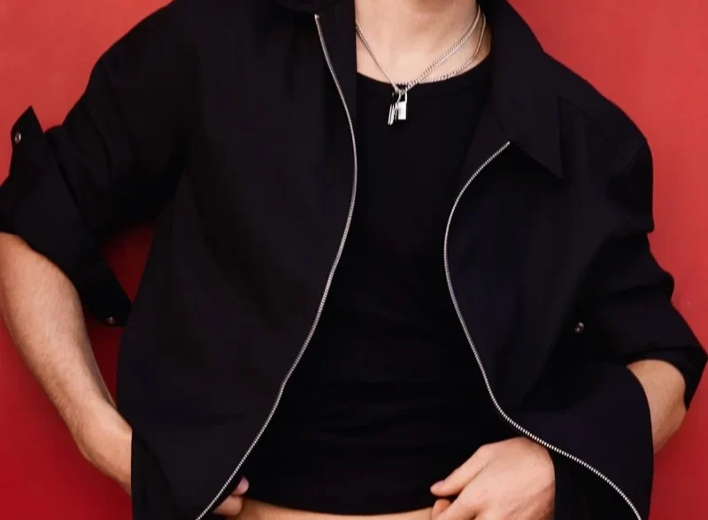 Michael Oder wearing an open dusty mauve shirt and layered silver necklaces for H&M Summer 2026