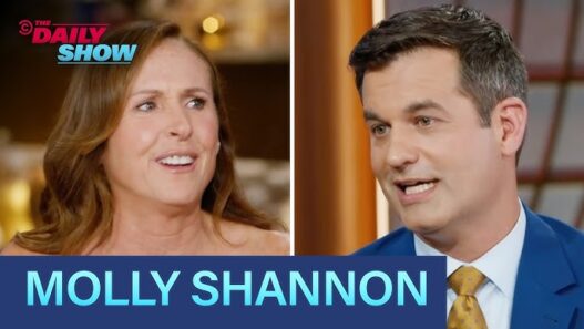 Molly Shannon smiles during her interview with Michael Kosta on The Daily Show