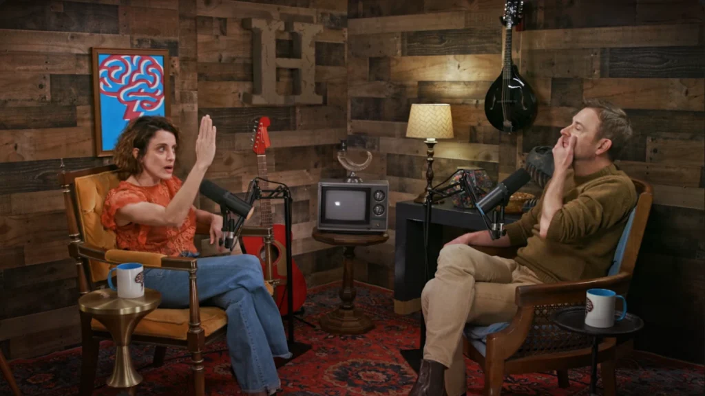 Chris Hardwick listening to Alanna Ubach during their podcast conversation