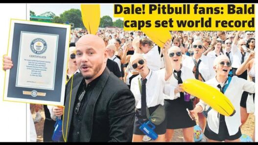 Pitbull fans wearing bald caps, aviator sunglasses and black suits during the Guinness World Record attempt at BST Hyde Park