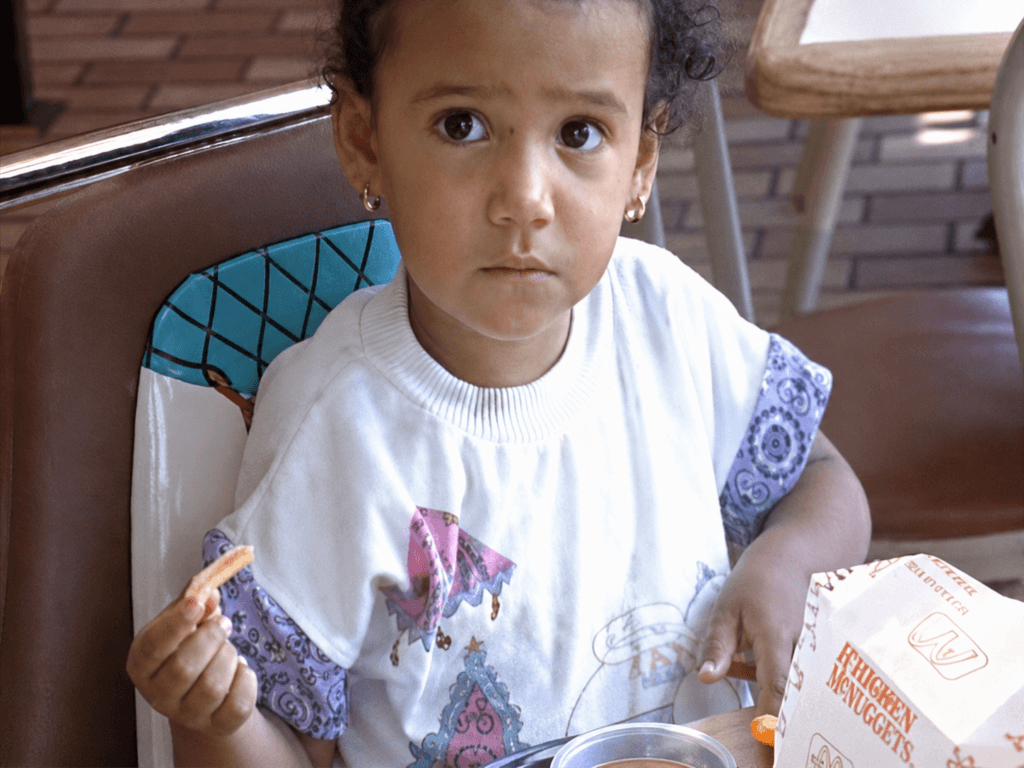 A child sits at a table inside a McDonald’s restaurant in 1990