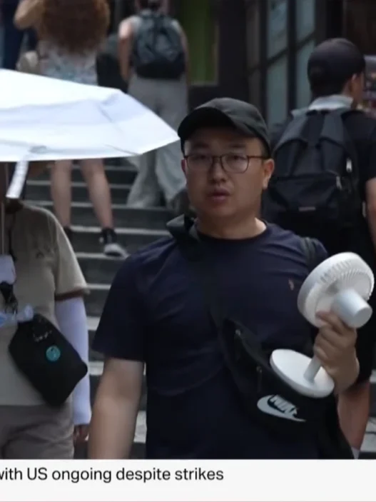 Japan’s summer heat has become so extreme that residents are carrying umbrellas, salt tablets and even full-size desk fans outside as temperatures hit 104°F.