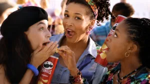 Kym Whitley sharing Pringles with two women in a scene from her 1994 television commercial.