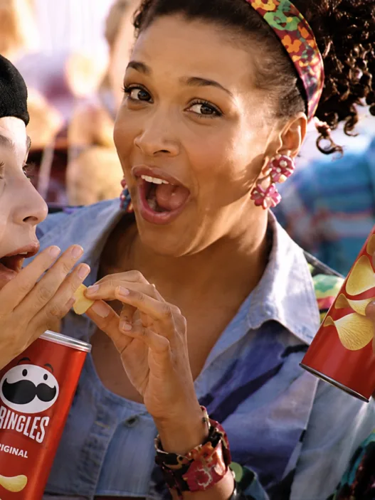 Kym Whitley sharing Pringles with two women in a scene from her 1994 television commercial.