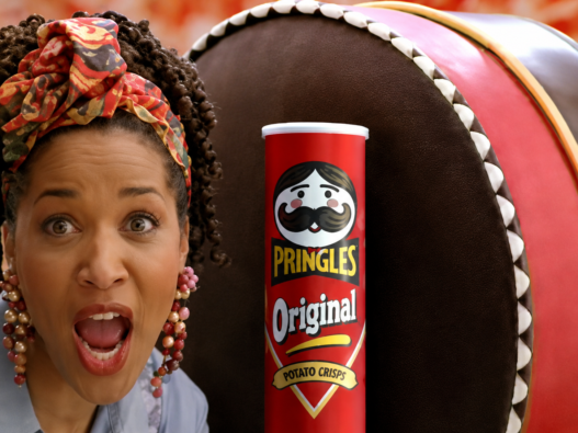Kym Whitley poses beside stacked Pringles Double Stacks cans in her 1994 television commercial