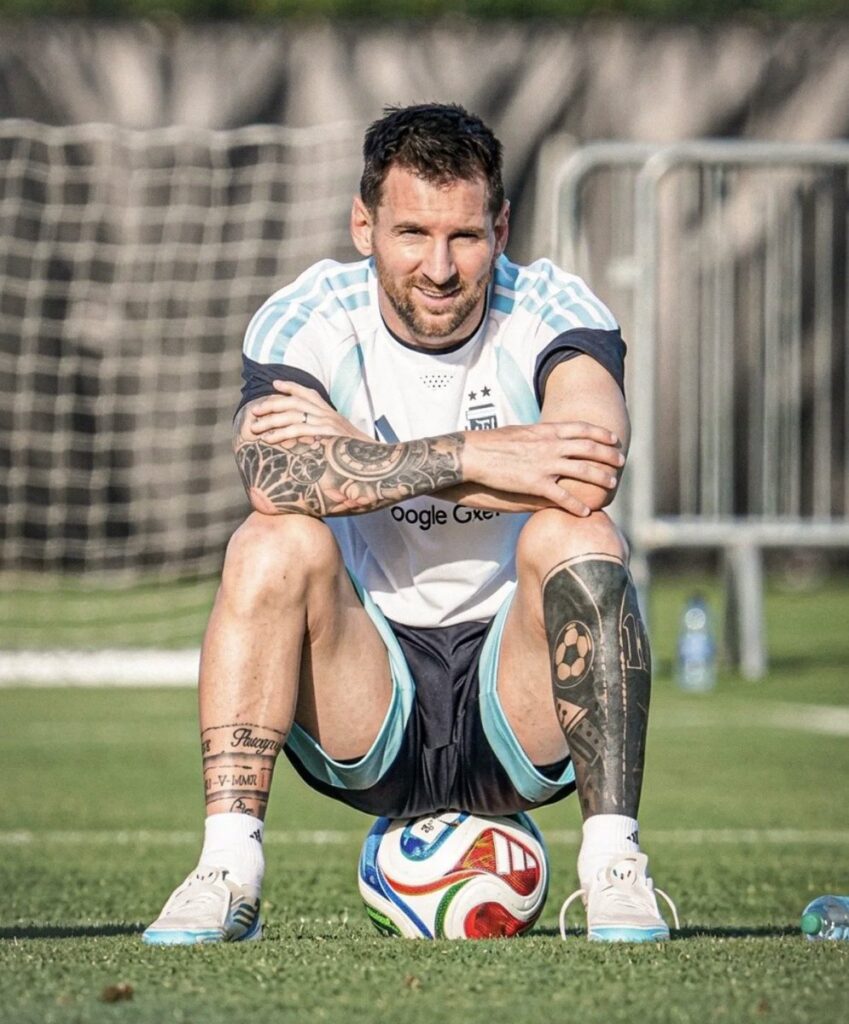 Argentina player seated on a soccer ball during training for a FIFA World Cup 2026 rest day story before the quarterfinals.