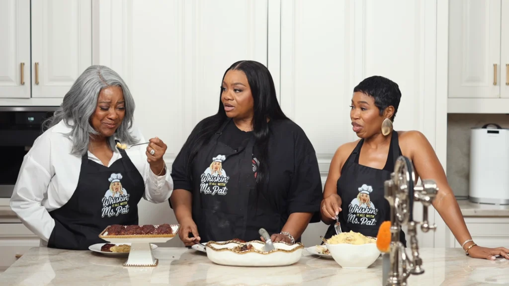 Loretta Devine and Miss Pat reacting during the meatloaf preparation