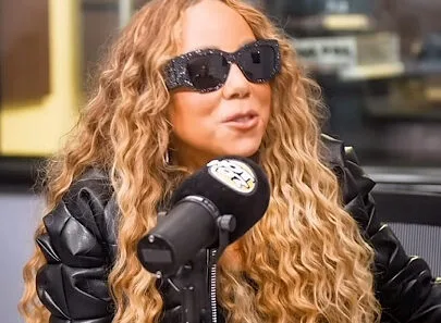 Mariah Carey laughing during her HOT 97 interview with Nessa about visiting a strip club