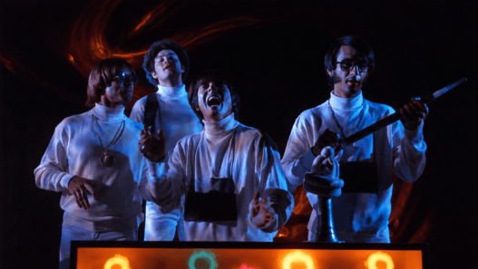 The Monkees perform Star Collector in a psychedelic television scene.