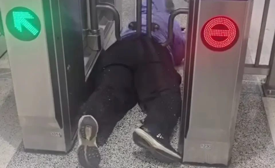 Woman caught beneath a BART fare gate at a San Francisco station