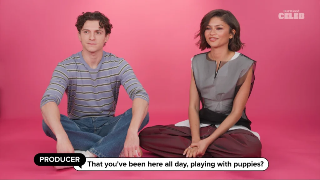 Tom Holland plays with energetic puppies on the BuzzFeed studio floor