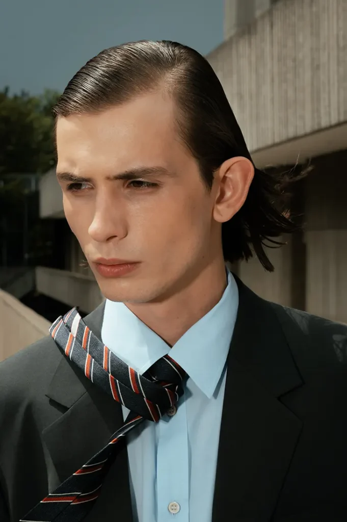 Anton Kügler in a dark suit, blue shirt and striped tie outdoors