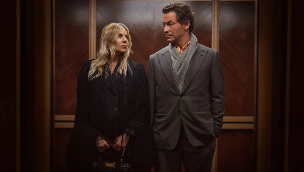 Sienna Miller as Carla Duval and Dominic West as Morgan Henderson standing together in WAR
