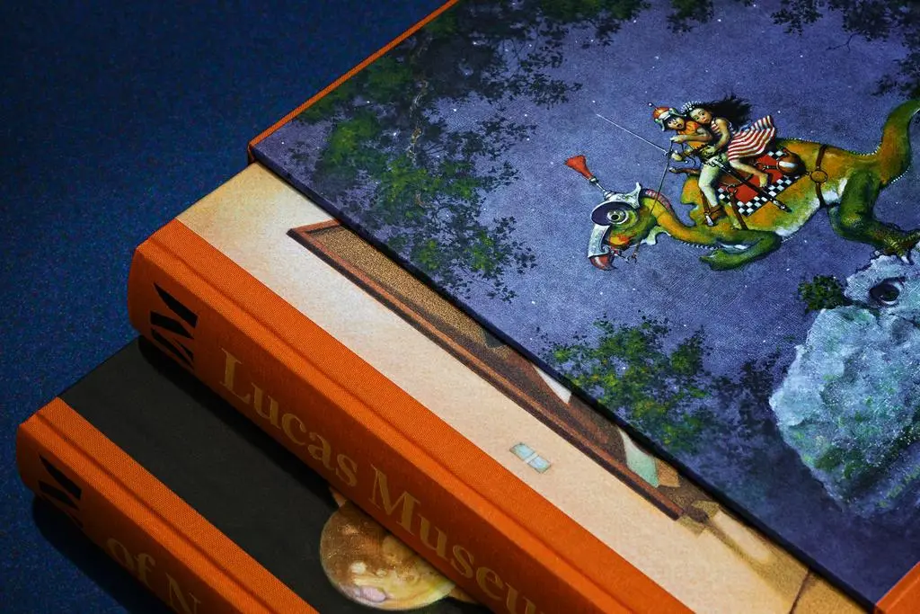 Close-up detail of the illustrated Lucas Museum of Narrative Art slipcase and orange book spine.
