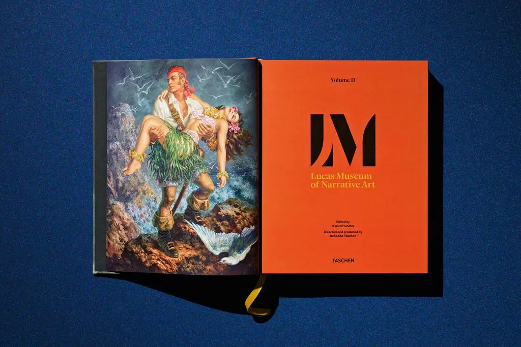 Open Lucas Museum of Narrative Art book showing illustrated artwork beside an orange Lucas Museum divider page.
