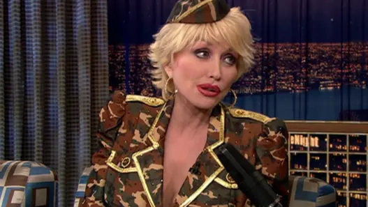 Dolly Parton with short blonde hair and a military-inspired camouflage outfit on Conan in 2003