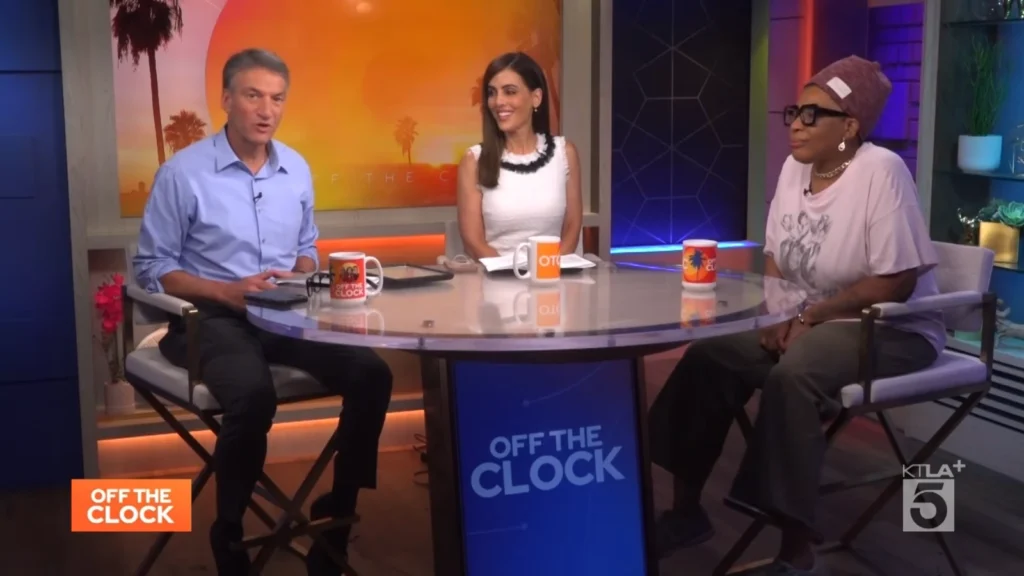 Macy Gray seated with two hosts on the KTLA 5 Off the Clock set