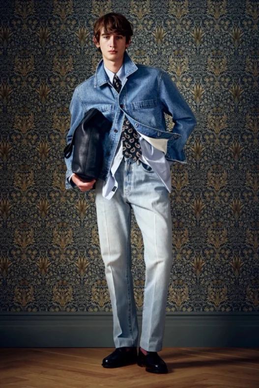 Todd Snyder Fall 2026 look with a rose-toned overcoat layered over dark tailoring.