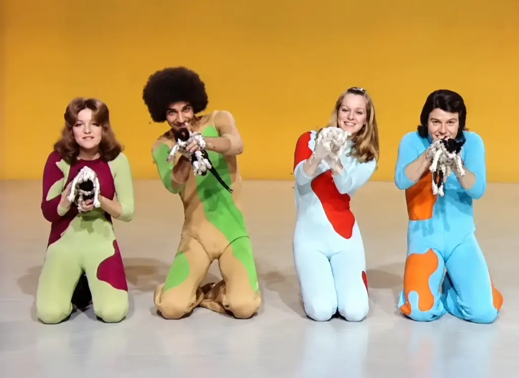 Four Ballet Zoom dancers kneel in colorful 1970s costumes during a psychedelic cat-themed television performance