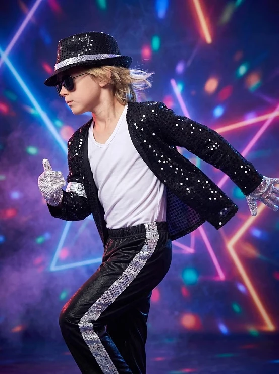 Child wearing a black sequined dance-star Halloween costume with hat sunglasses and silver gloves