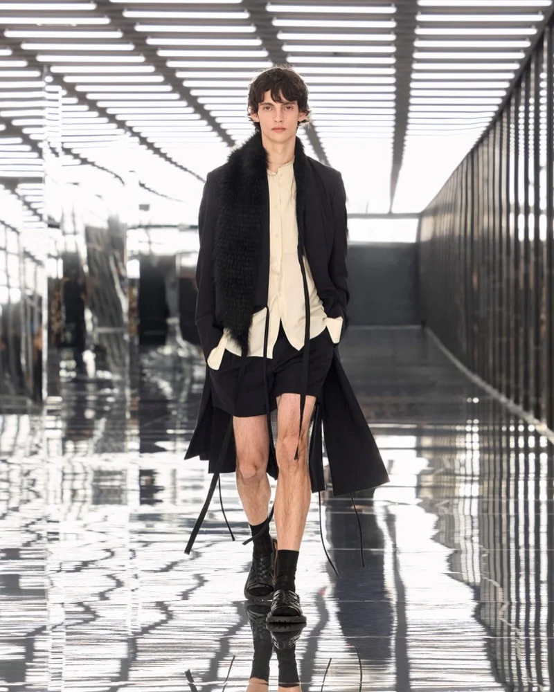 Fendi Spring Summer 2027 menswear look with long coat, fur stole and shorts