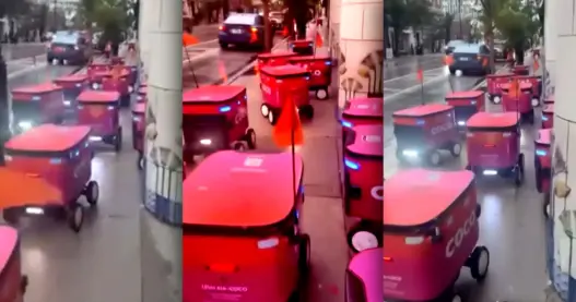 Coco delivery robots clustered together on a Chicago sidewalk near Lincoln Park