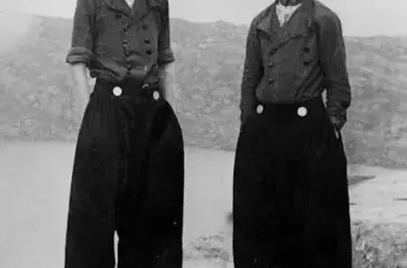 Dutch fishermen in traditional regional clothing with wide trousers