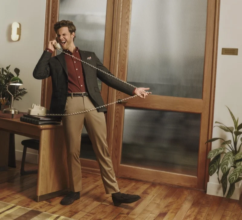 Jack Quaid in oxblood blazer by a window for Bonobos Fall 2026