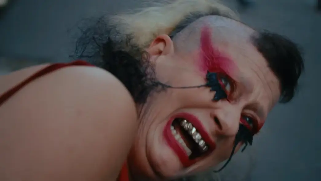 Peaches in the NOWNESS art film for “You’re Alright,” surrounded by surreal creature-drag imagery