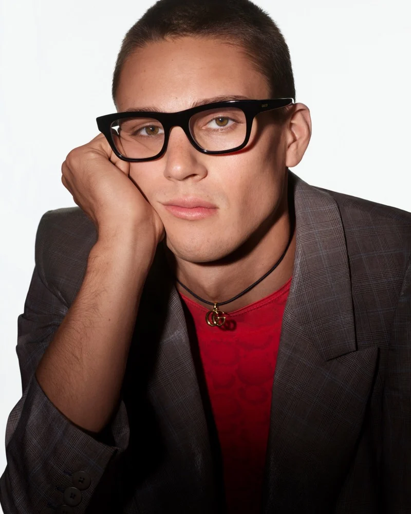 Samuel Watson in black rectangular Gucci optical frames, a gray check blazer and red top for Fall 2026