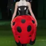 Model in a sculptural red-and-black ladybug dress on the Thom Browne Spring 2027 runway