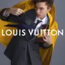 Louis Vuitton Spring-Summer 2027 menswear campaign model wearing a tailored suit beneath a bright yellow raincoat