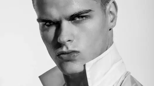 Black-and-white close-up of Treston Francis in a white shirt photographed by Frank Louis