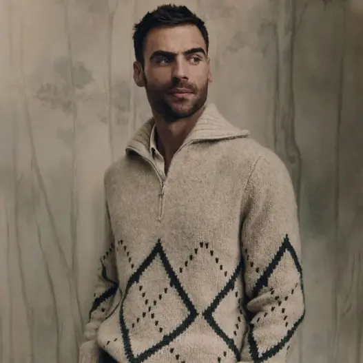 George Alsford wearing a brown shearling-collar jacket over dark tailored suiting for Brunello Cucinelli Winter 2026.