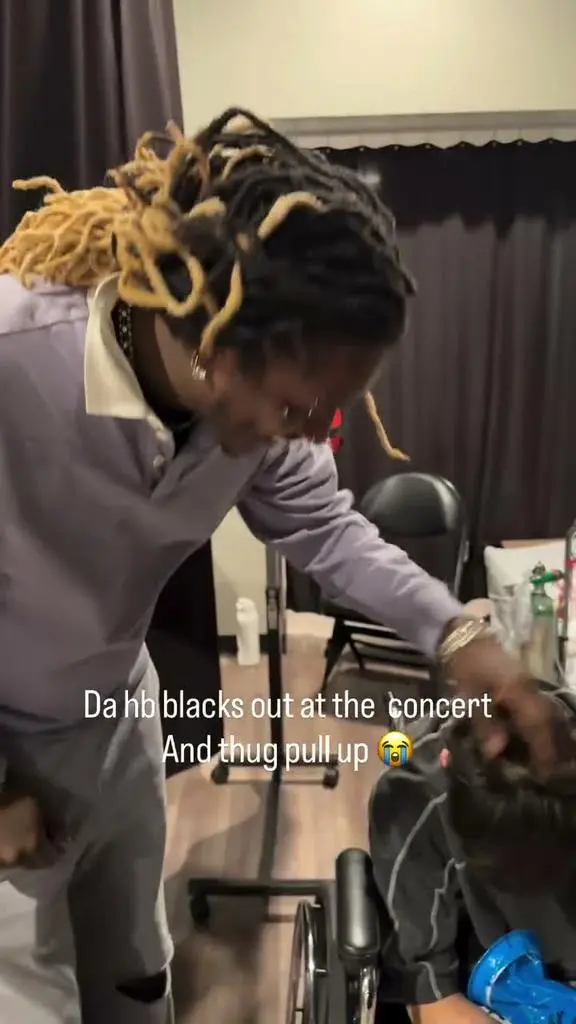 Young Thug beside the seated concertgoer backstage