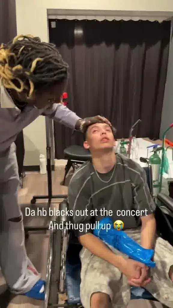 Young Thug laughing beside the concertgoer backstage