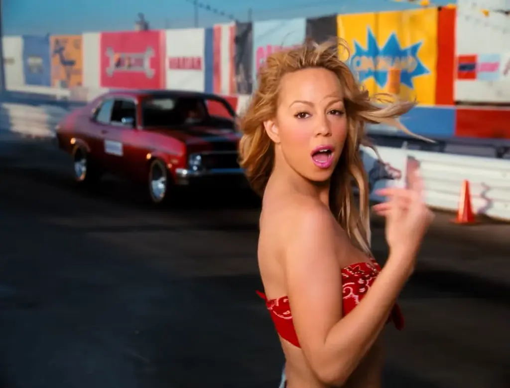 Mariah Carey in a red patterned top in the restored Loverboy Remix music video