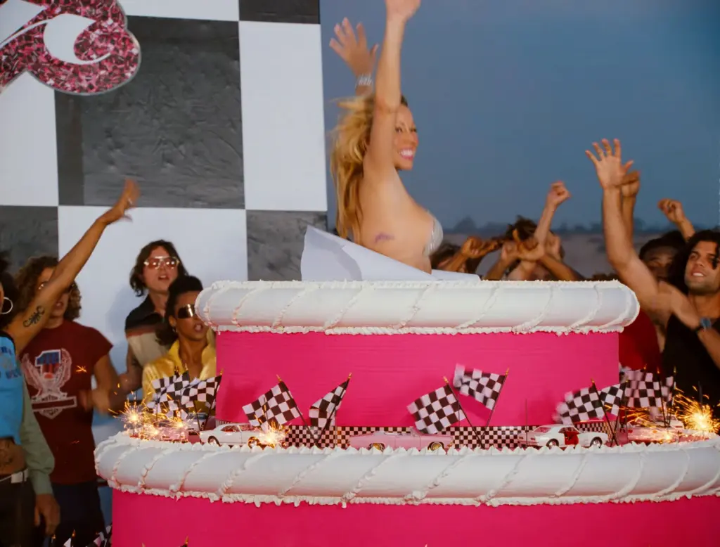 Mariah Carey rising from a giant pink cake in the restored Loverboy Remix music video