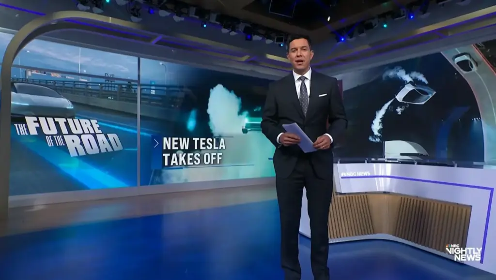 Tom Llamas stands in the NBC Nightly News studio beside a graphic about Tesla’s Roadster and the future of driving.