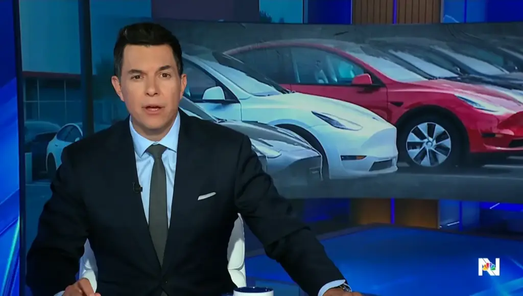 Tom Llamas in the NBC Nightly News studio with several Tesla vehicles shown on the background screen