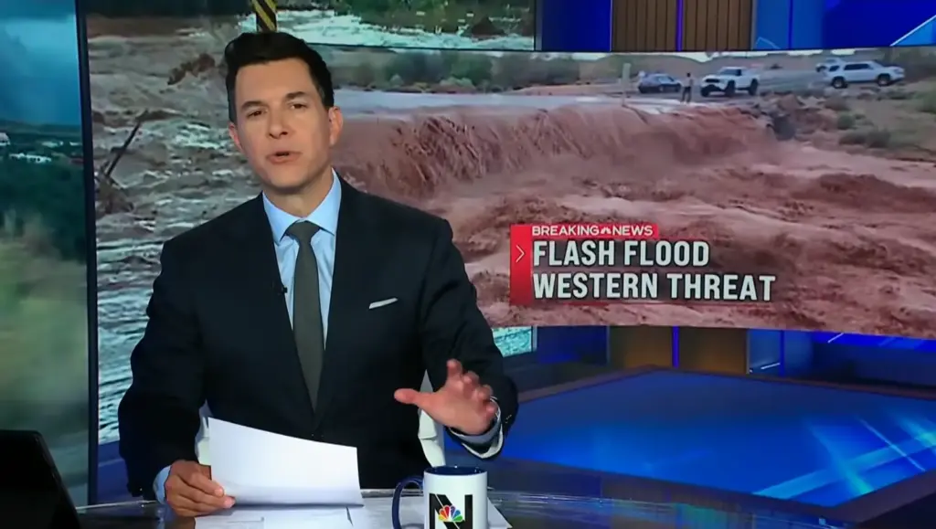 Tom Llamas presents NBC Nightly News with a flash flood warning graphic behind him