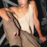 Backstage model wearing a sleeveless top, relaxed trousers and black shoes from O’BARRET's Soulstice collection at 080 Barcelona Fashion 2026.