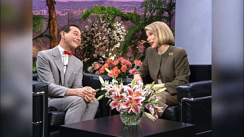 Pee-wee Herman and Joan Rivers smiling together during their 1989 talk-show interview