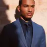 Model Paulo Lopes Lucio wearing a tailored blue suit, navy shirt and patterned tie in Peter Jackson Australia's Destination: Summer 2026 campaign, photographed by Alfi Gomez.