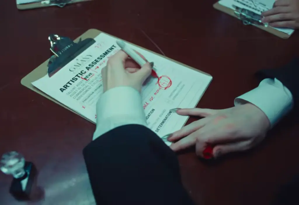 Close-up of hands marking a printed form with a red pen in the Church of Sound music video