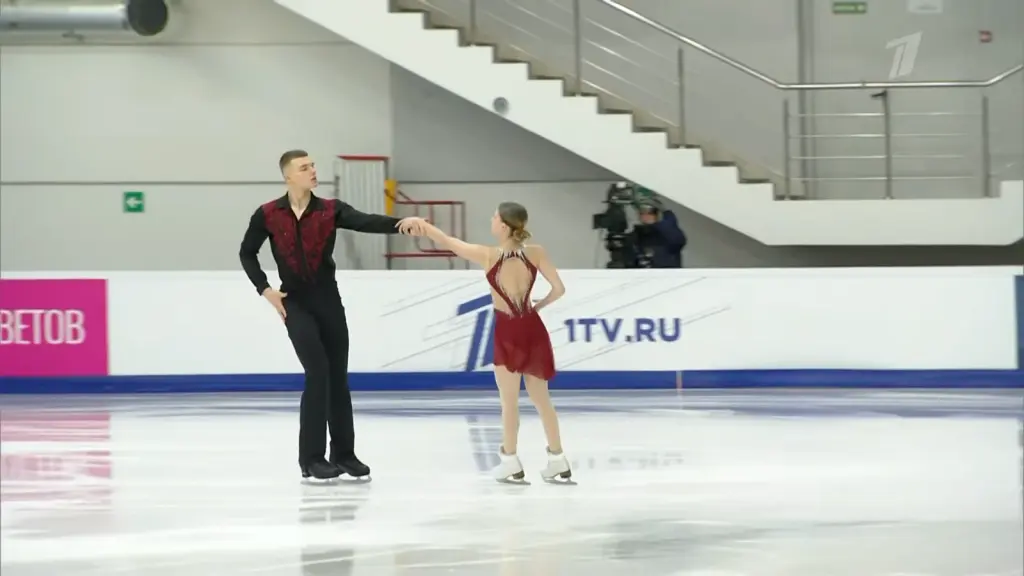 Alexander Samorukov seated beside Darya Tretyakova after skating