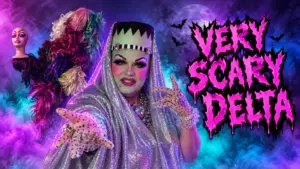Delta Work in a glamorous Frankenstein-inspired drag look with silver sequins, neon fog, and “Very Scary Delta” Halloween title text.