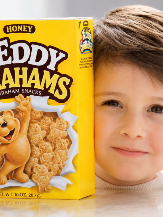 Child holding a box of Honey Teddy Grahams in a restored vintage-style commercial image.